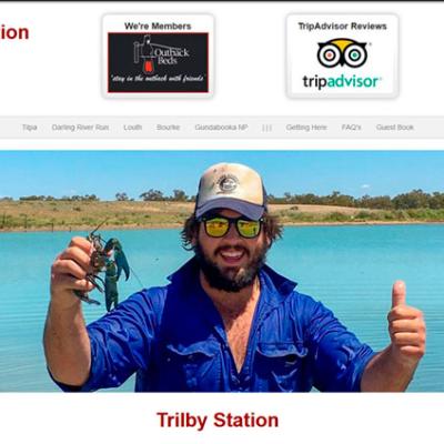 Website design for Trilby Station showing a man holding a yabby with TripAdvisor and Outback Beds badges